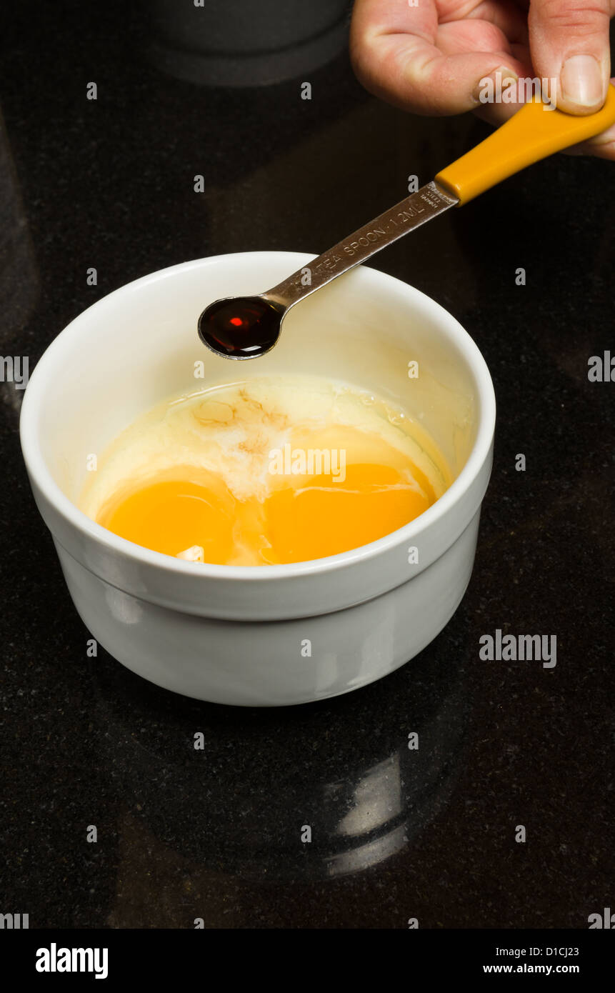 A baker measures ingredients into a bowl Stock Photo Alamy