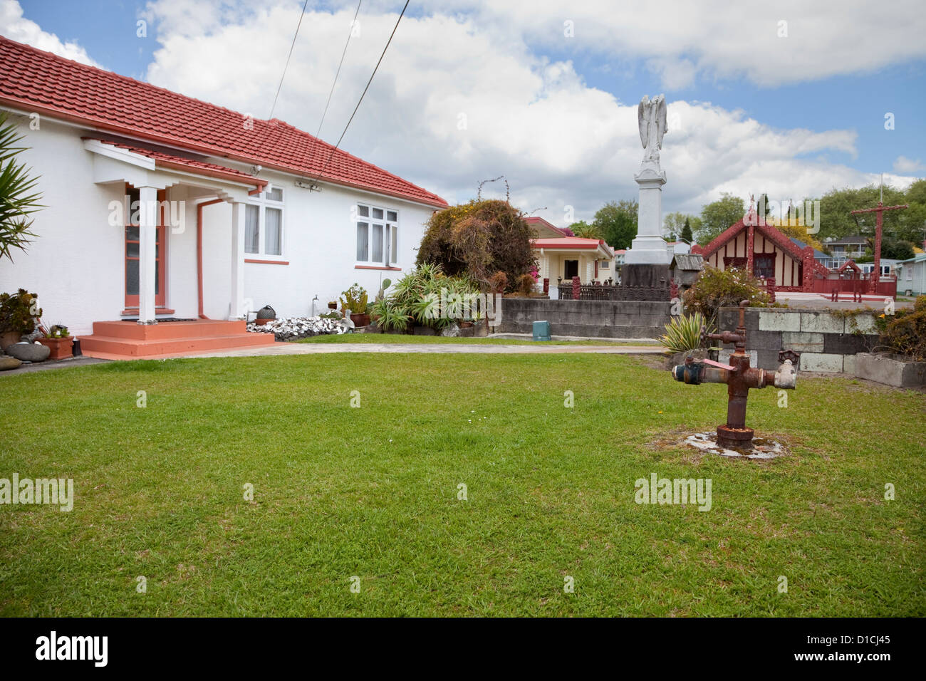 This 'thermal bore' in the yard of a resident's house identifies one of forty houses heated with geothermal steam.  Rotorua, NZ. Stock Photo