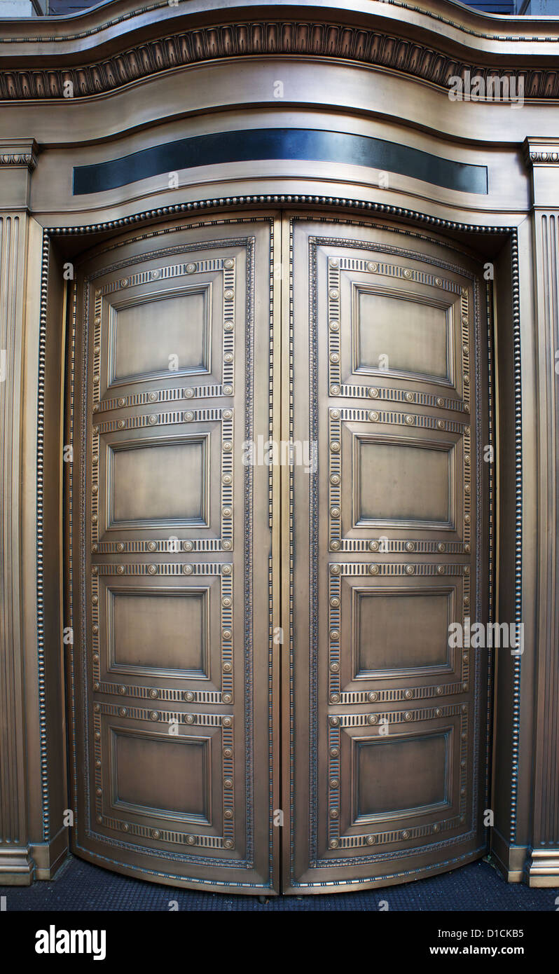 Large curved brass closed doors on a bank entrance Stock Photo
