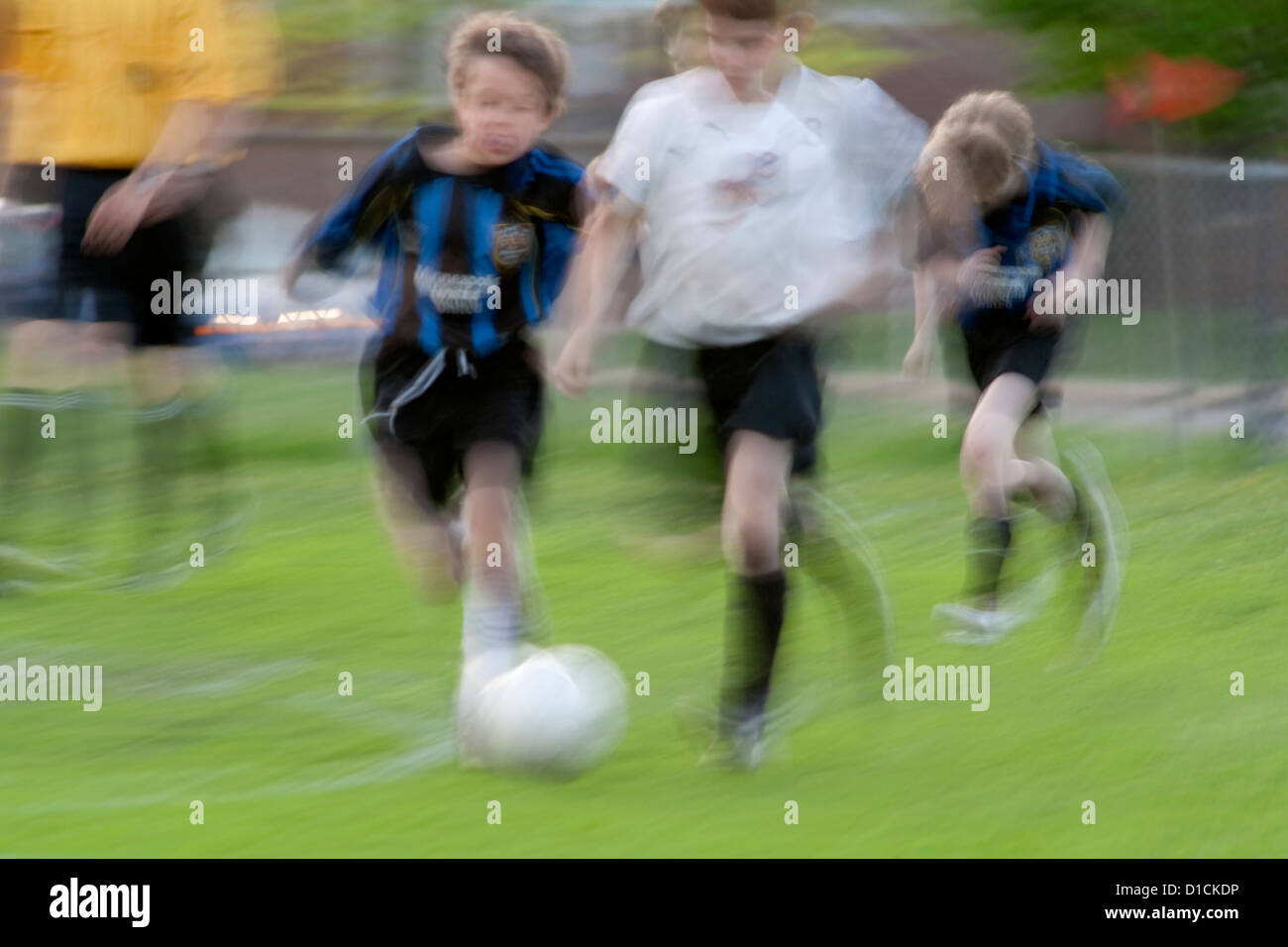 Boys age 10 playing soccer game blurred to show action. Monroe Memorial Park St Paul Minnesota MN USA Stock Photo