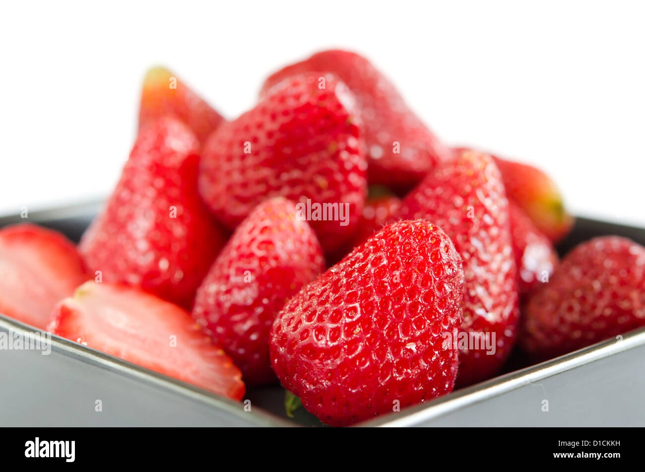 Fresh strawberries on black plate over white Stock Photo - Alamy