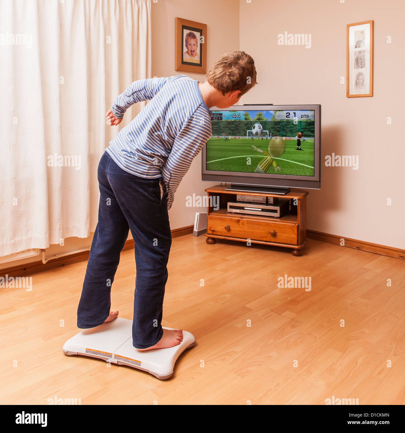 A 9 year old boy playing on a Nintendo Wii Fit board Stock Photo - Alamy
