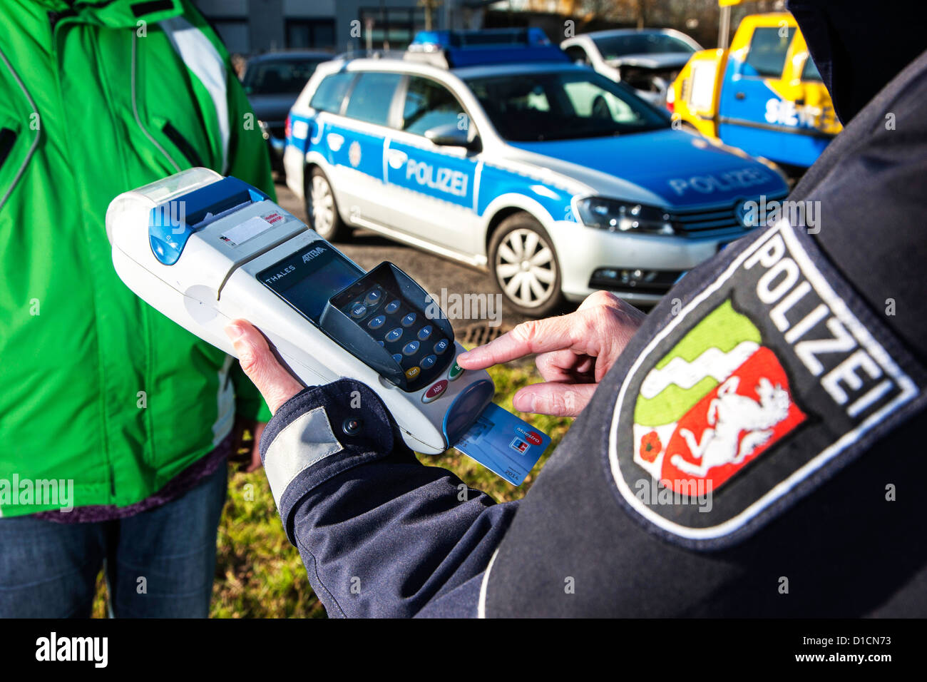 Police. A car driver have to pay a fine, speeding ticket. Payed by credit card. Stock Photo