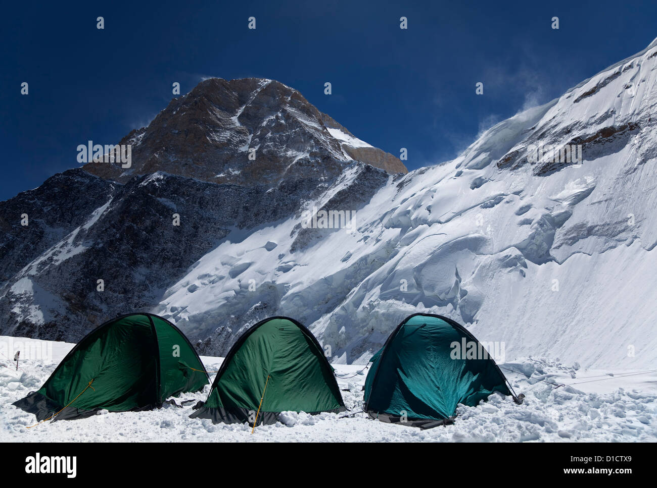 Tents in High-altitude Camp 2, 5,500 m, 18,000 ft, on North Face of Khan Tengri peak, 7,010 m, 22,999 ft, Tian Shan mountains Stock Photo