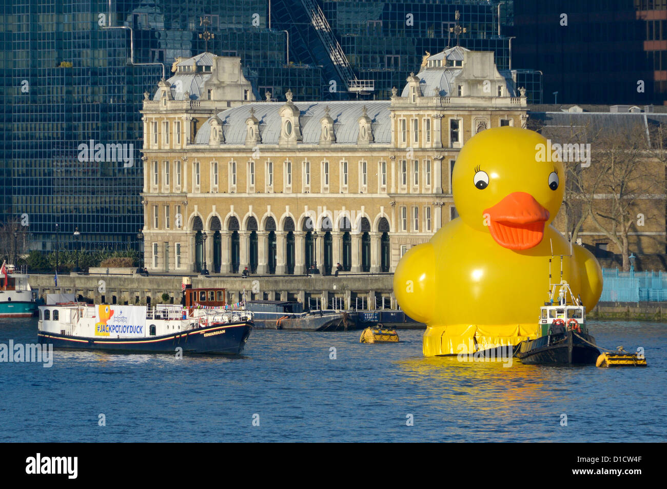 Yellow duck and tug boat moored in the Pool of London alongside a publicity barge promoting the Jackpotjoy bingo website Stock Photo