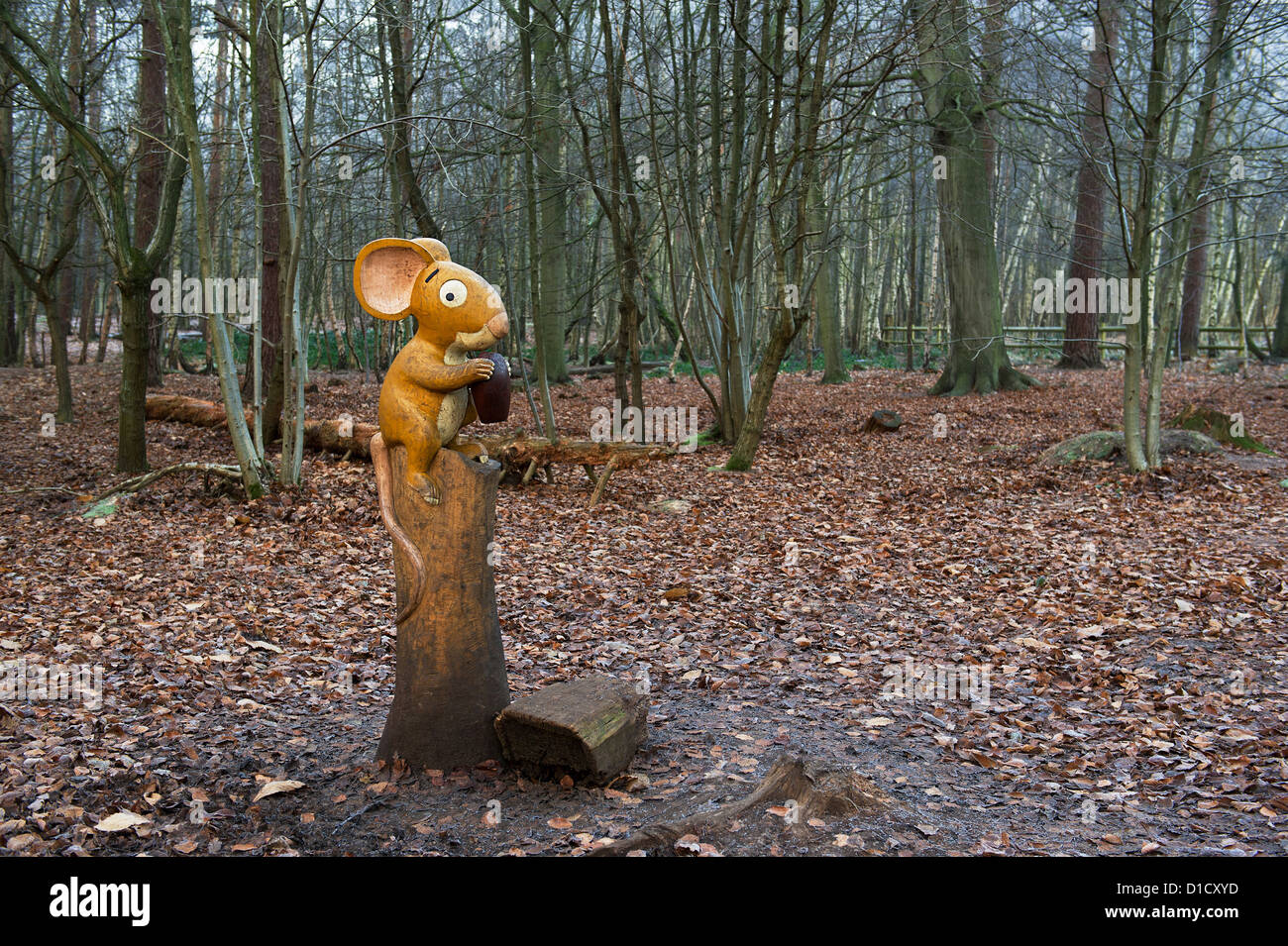 A wooden sculpture of a mouse eating an acorn in Thorndon Country Park in Essex. Stock Photo