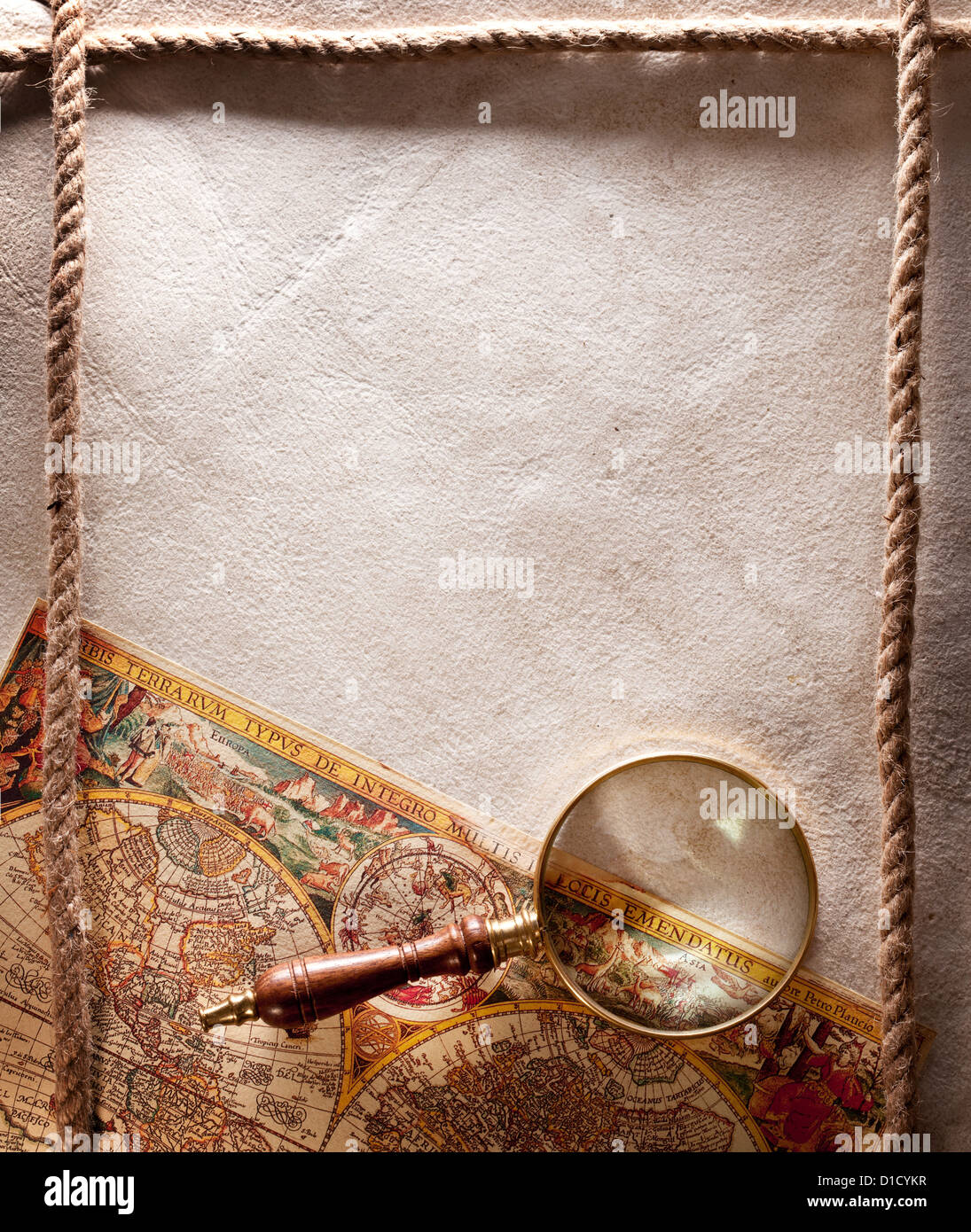 Magnifying glass on old parchment. Stock Photo
