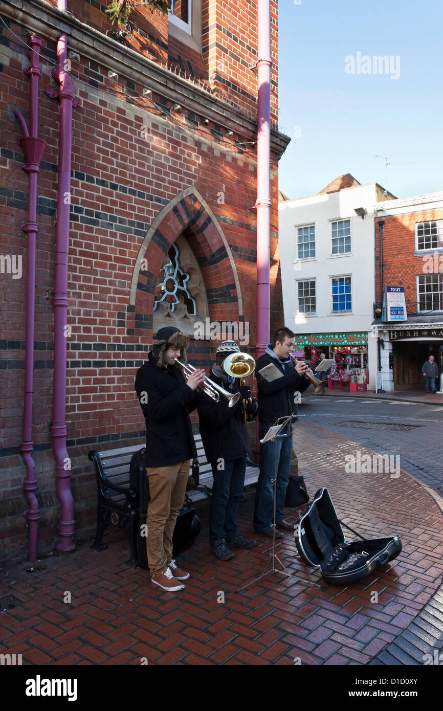Street musicians play Christmas Carols outside Wokingham Town Hall in Berkshire, England. Stock Photo