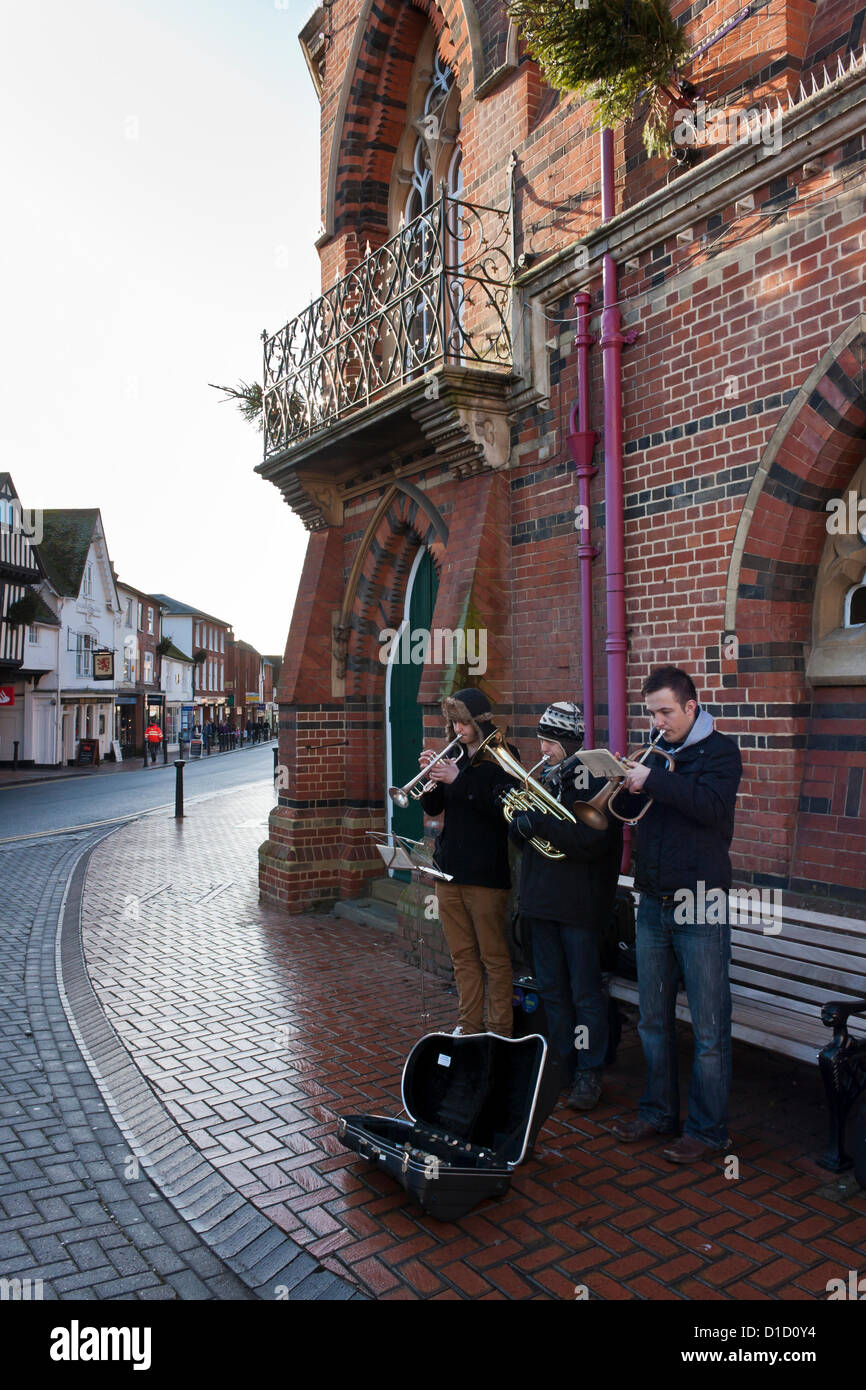 Street musicians play Christmas Carols outside Wokingham Town Hall in Berkshire, England. Stock Photo