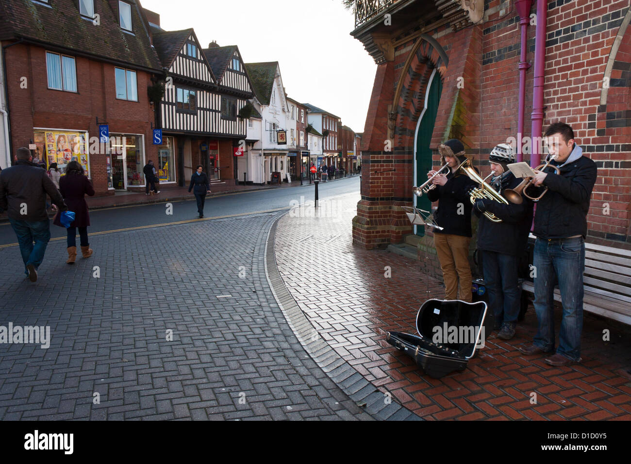 Street musicians play Christmas Carols outside Wokingham Town Hall in Berkshire, England. Stock Photo