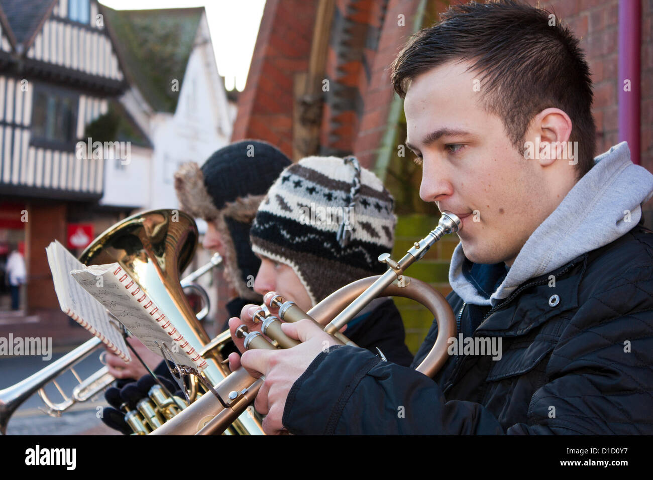 Street musicians play Christmas Carols outside Wokingham Town Hall in Berkshire, England. Stock Photo