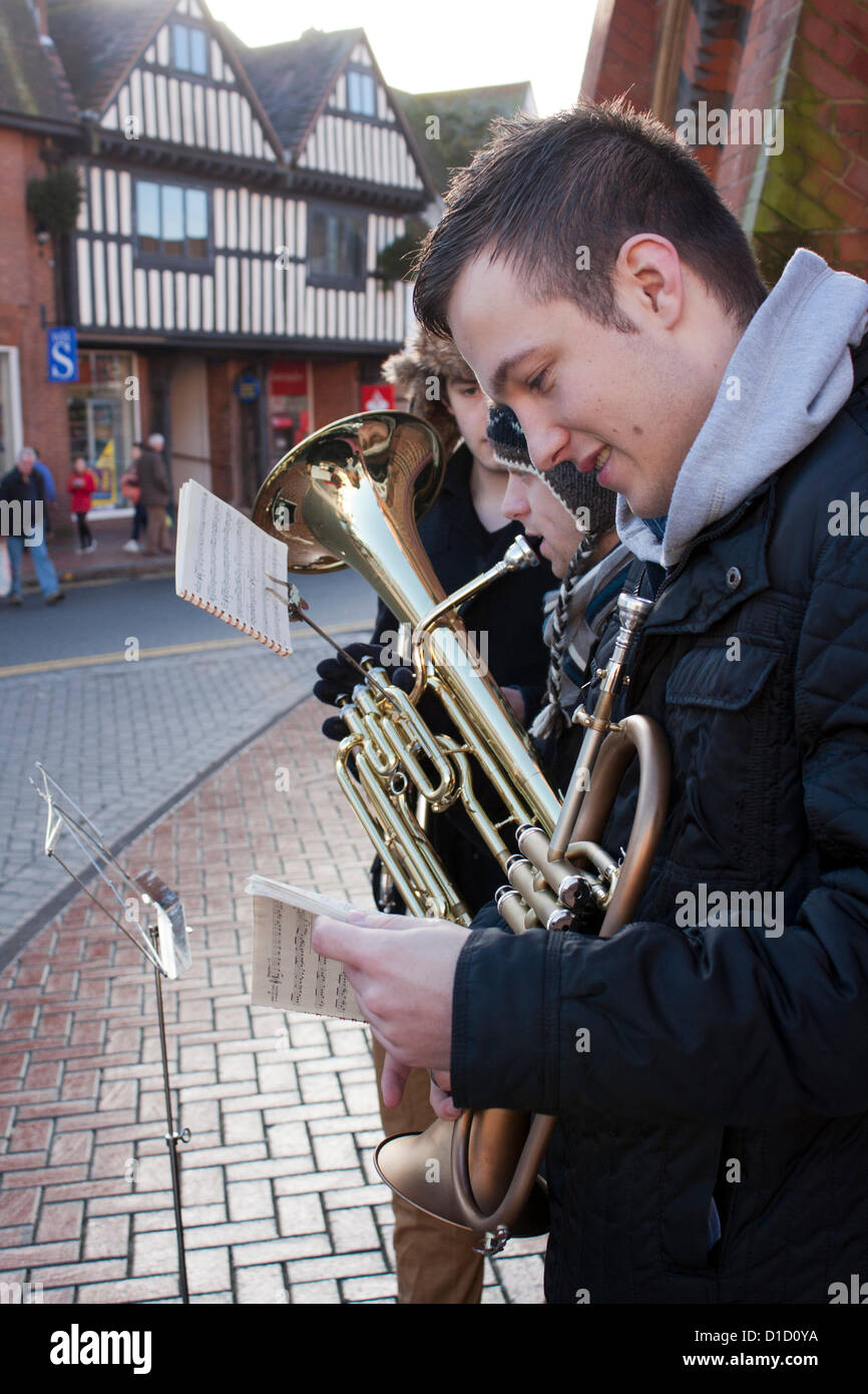 Street musicians play Christmas Carols outside Wokingham Town Hall in Berkshire, England. Stock Photo
