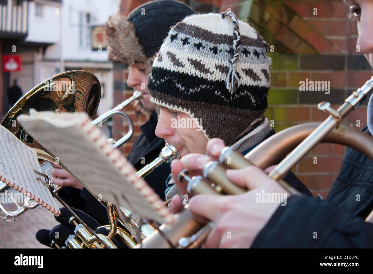 Street musicians play Christmas Carols outside Wokingham Town Hall in Berkshire, England. Stock Photo