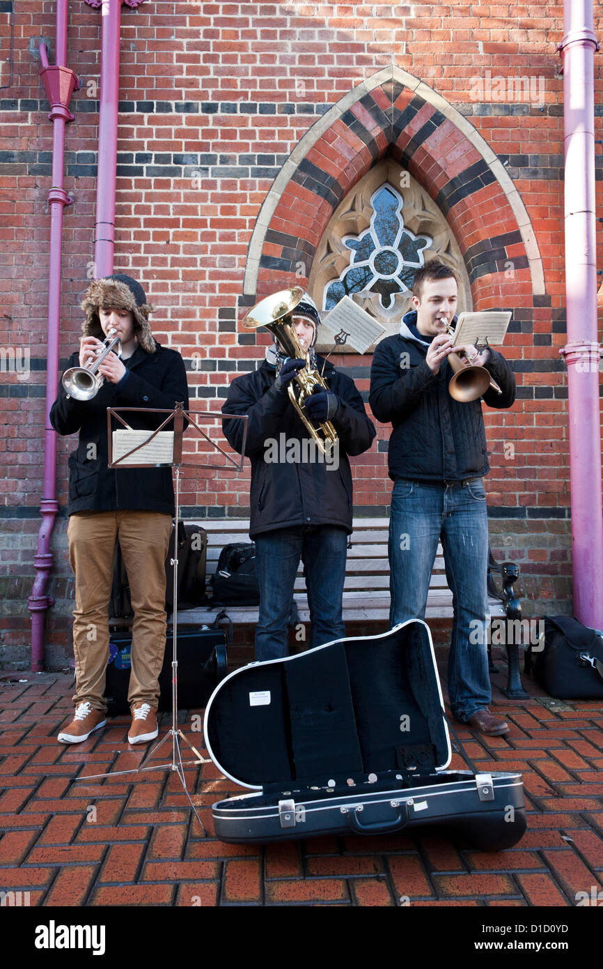 Street musicians play Christmas Carols outside Wokingham Town Hall in Berkshire, England. Stock Photo