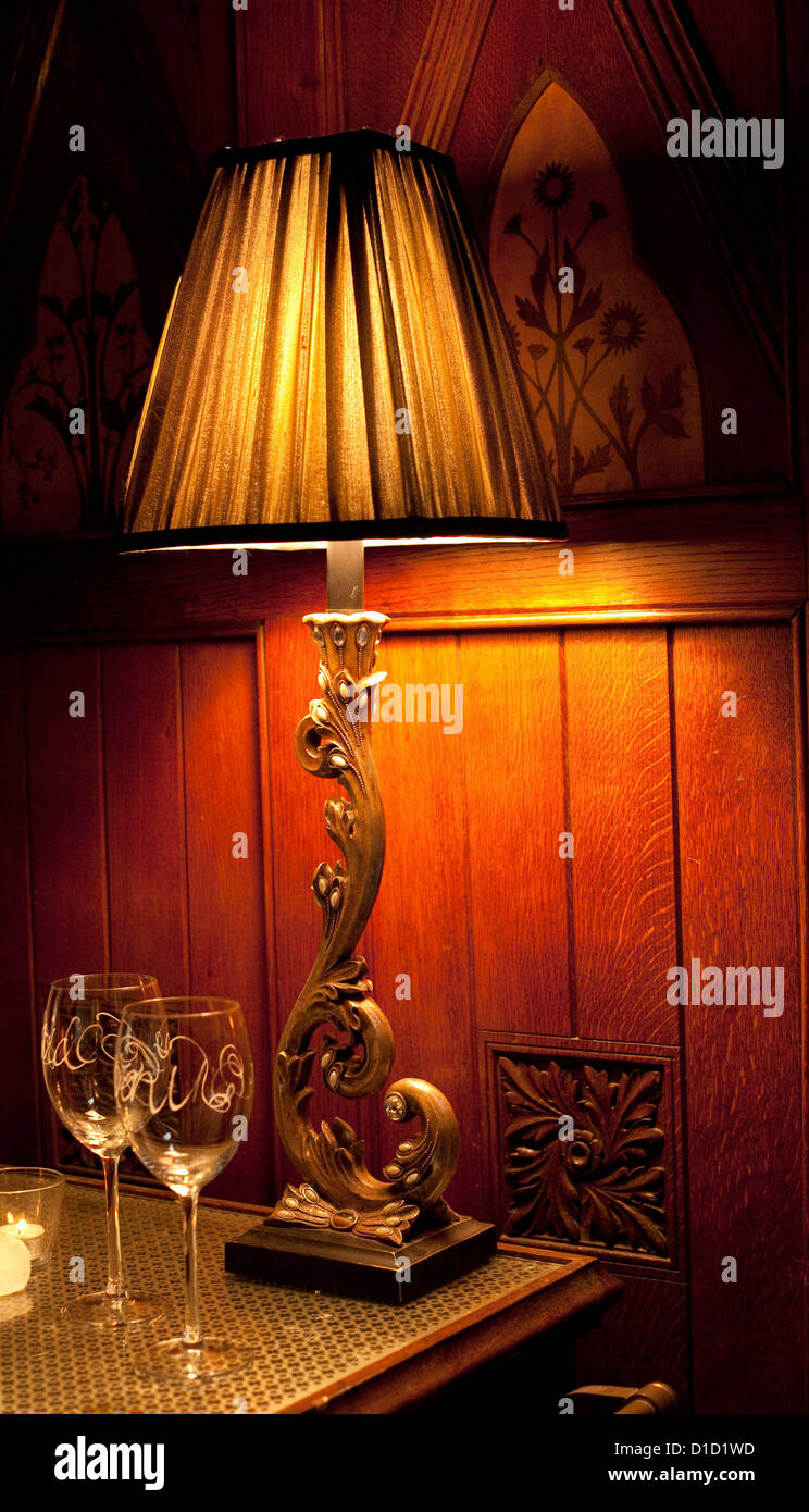 Wine glasses on table with lamp, England, UK Stock Photo