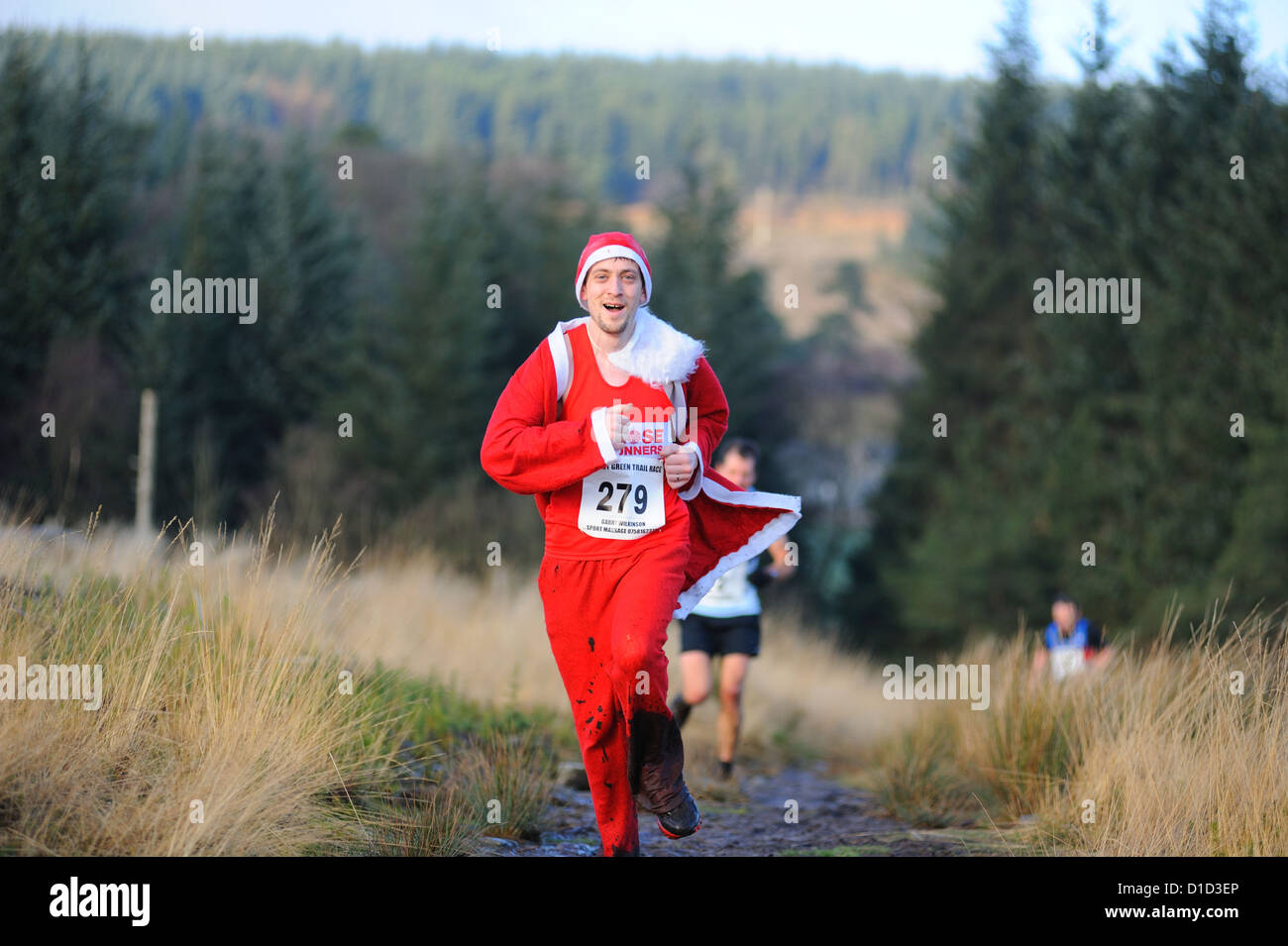 competitor in a christmas turkey trot trail race dressed as a santa Stock Photo