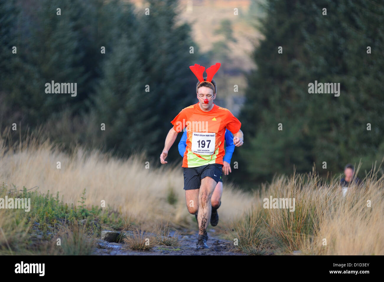Competitor in a christmas turkey trot trail race dressed as a reindeer Stock Photo