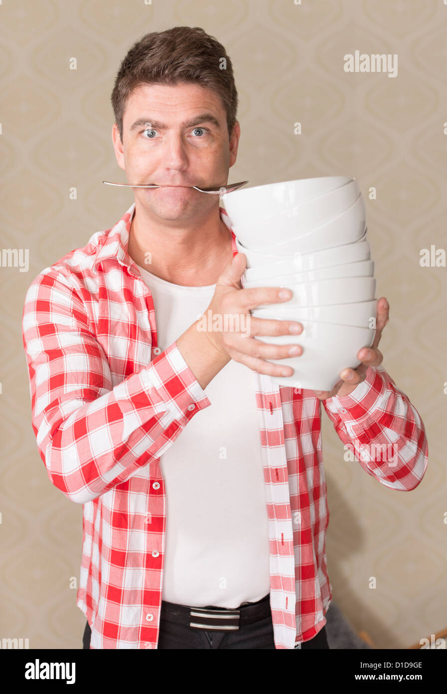 Frustrated adult male preparing meal in a hurry Stock Photo