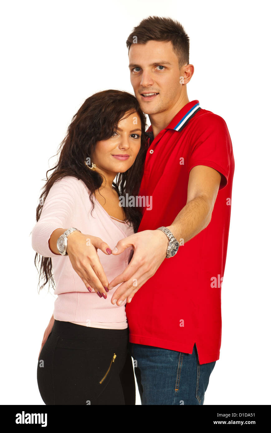 Young couple making heart shape with their hands isolated on white ...