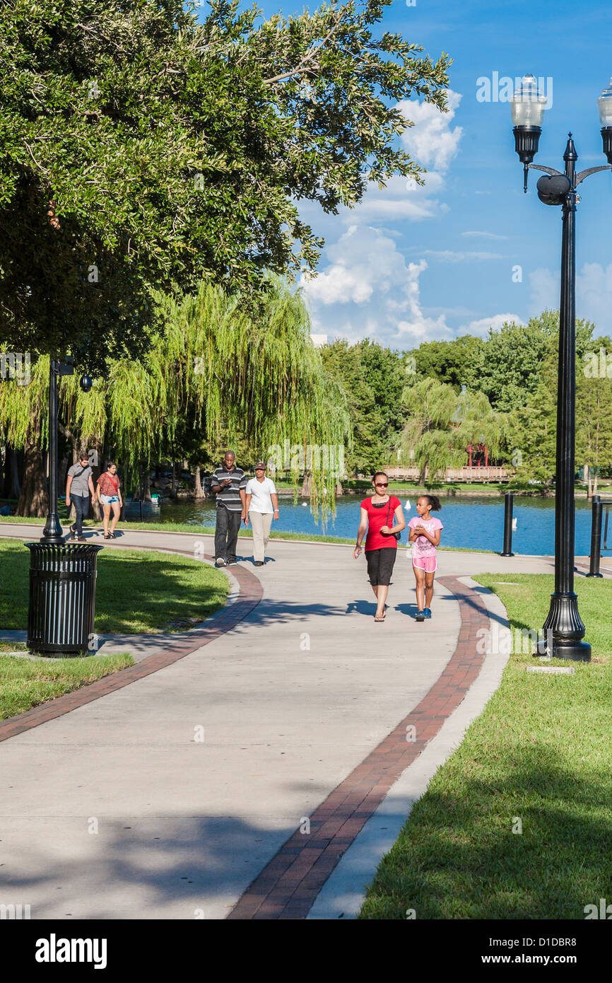 Multi-cultural people walking through Lake Eola Park in downtown Orlando, Florida Stock Photo