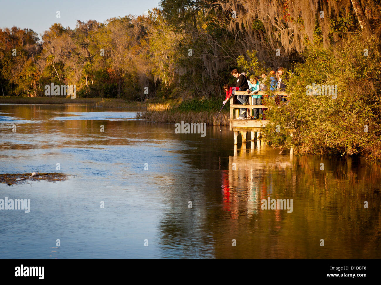 Family on wooden dock fishing on Rainbow River in Dunnellon, Florida Stock Photo