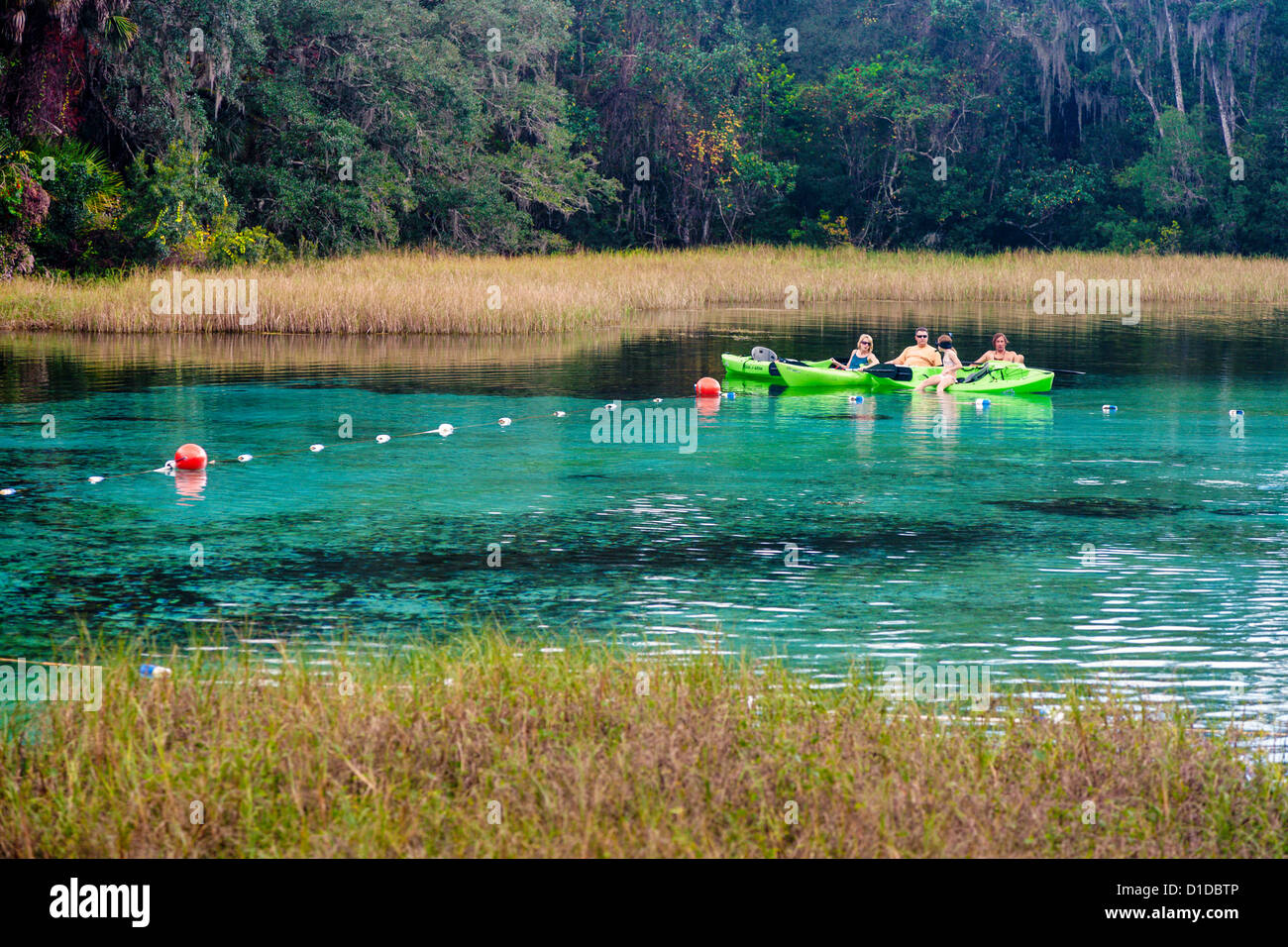 Kayakers take a break in the calm spring fed waters of the Rainbow River in Dunnellon, Florida Stock Photo