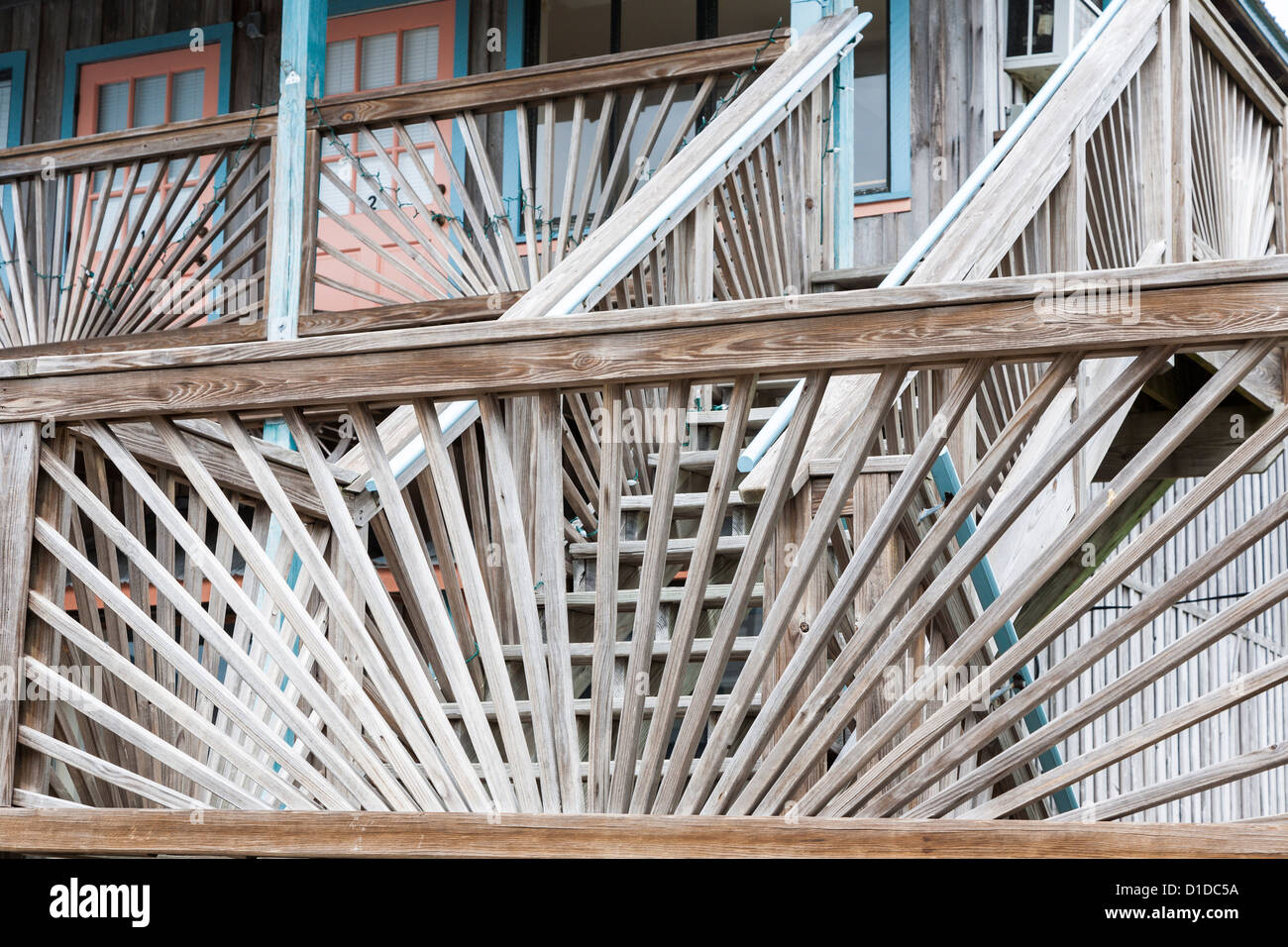 Weathered wooden balcony and stair railings in sunburst pattern on ...