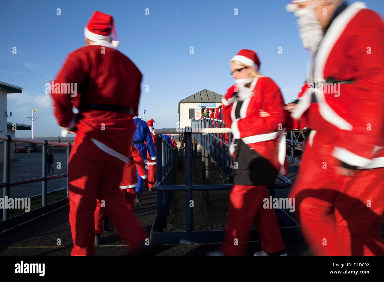 Southport, Merseyside, UK Sunday 16th December, 2012. Costumed runners and participants, seasonally dressed as Father Christmas, in the Queenscourt Hospice Christmas Santa Fun Run for Charity, a 1km route starting at Silcocks Leisure centre and following a route along the pier and round the Botanical Gardens Stock Photo