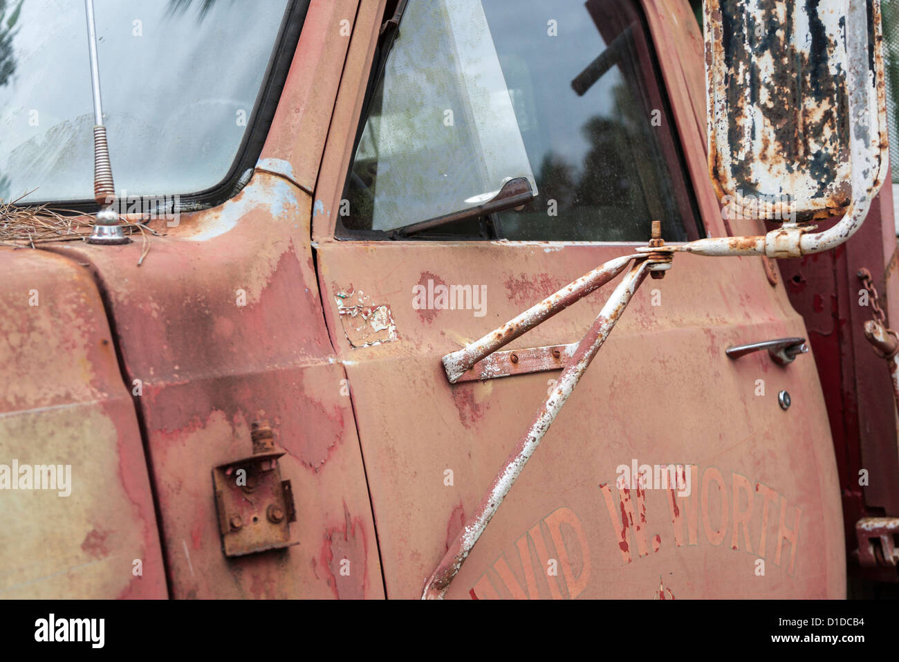 Detail of door and mirror on old antique GMC truck with rust and oxidized paint Stock Photo