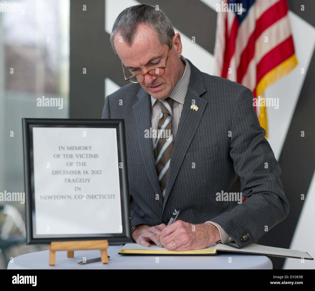Philip D. Murphy, US ambassador in Germany, signs in a condolence book for the victims of a massacre at an elementary school in Newton, US Embassy Berlin, Germany, 17 December 2012. 20 children and 6 people were killed during a killing spree in the city of Newton, Connecticut, US. Photo: Tim Brakemeier Stock Photo