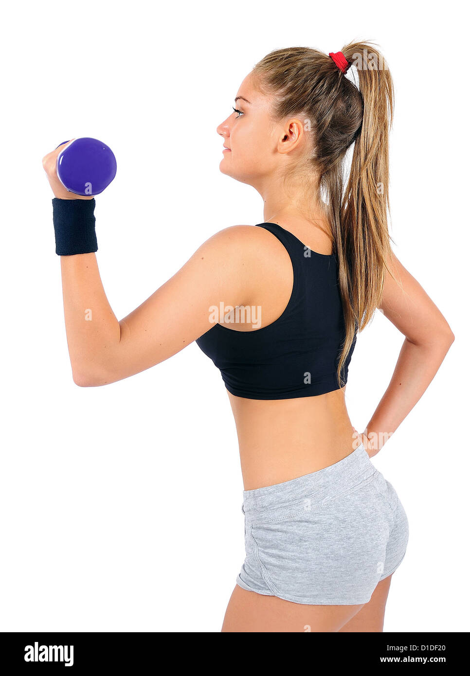 Isolated young fitness woman with dumbbell Stock Photo
