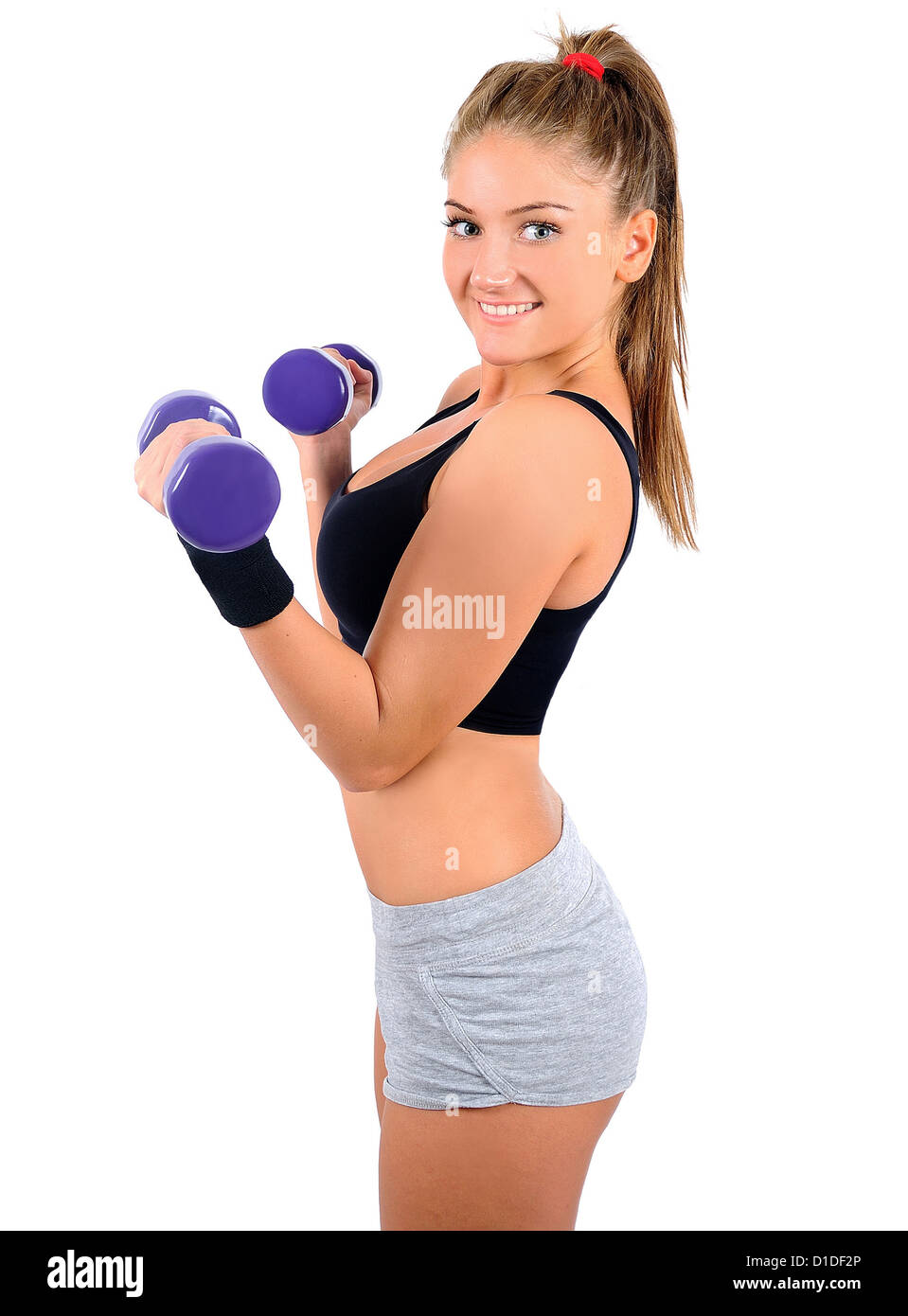 Isolated young fitness woman with dumbbell Stock Photo
