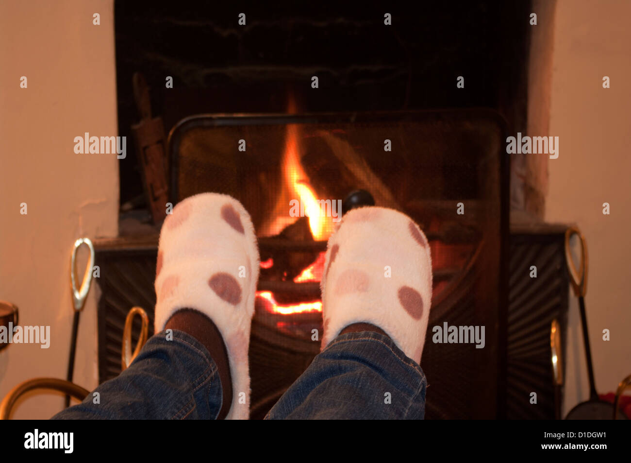 Warming Feet In Slippers By An Open Fire Stock Photo