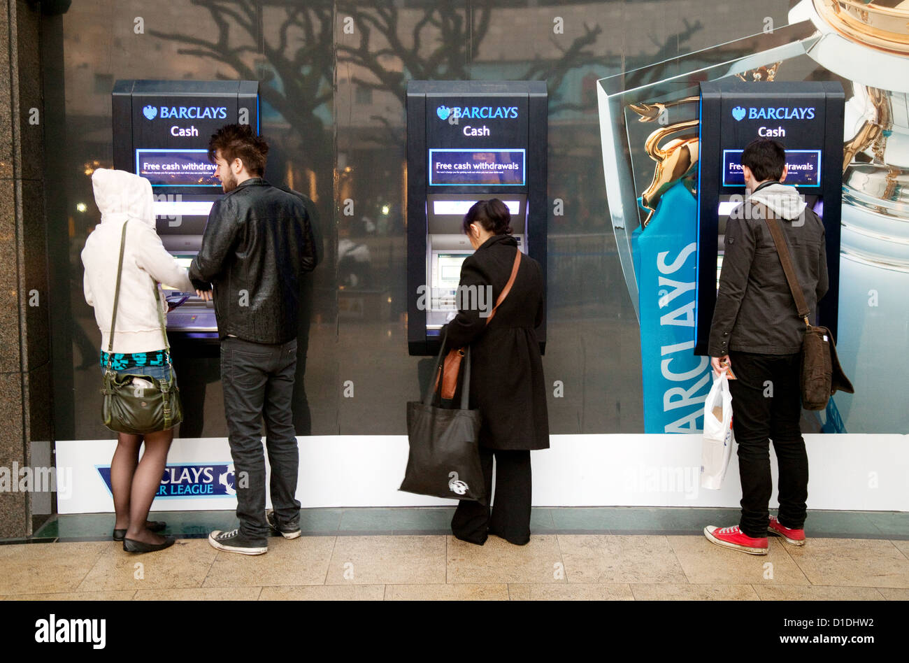 People getting money at three Barclays Bank ATMs, MK Centre, Milton Keynes Buckinghamshire UK Stock Photo