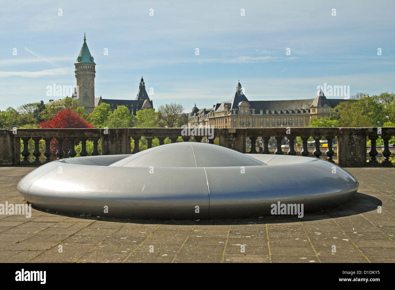UFO sculpture in Luxembourg City. The tower of the Banque et caisse d'épargne de l'État (BCEE) is in the background. Stock Photo