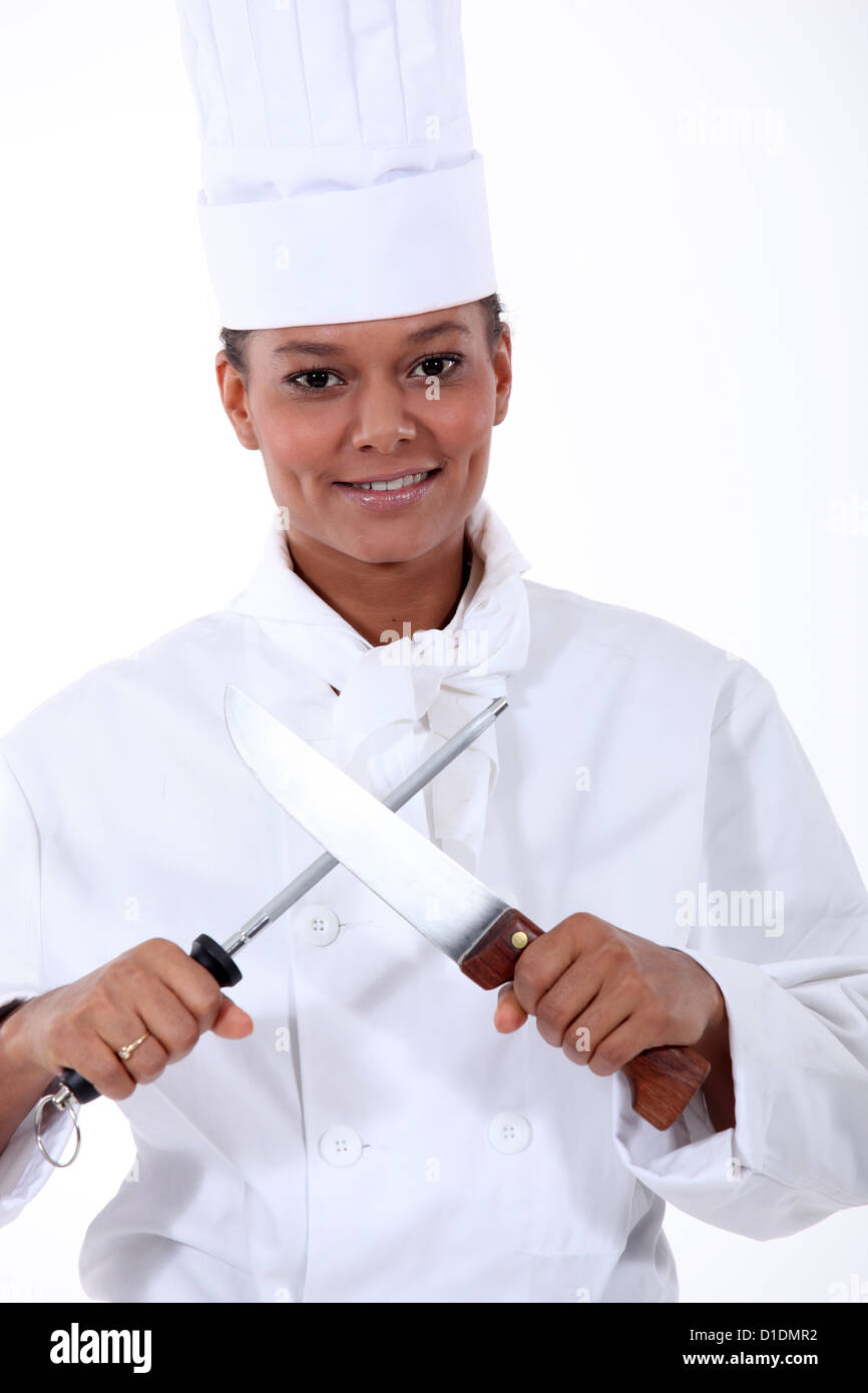 Chef sharpening a kitchen knife with a steel Stock Photo Alamy