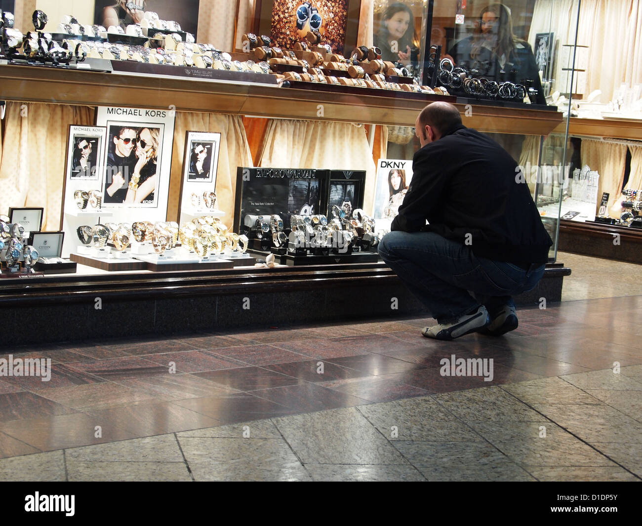 Man shopping for a new watch in a jewelers, Cribbs Causeway, Bristol 