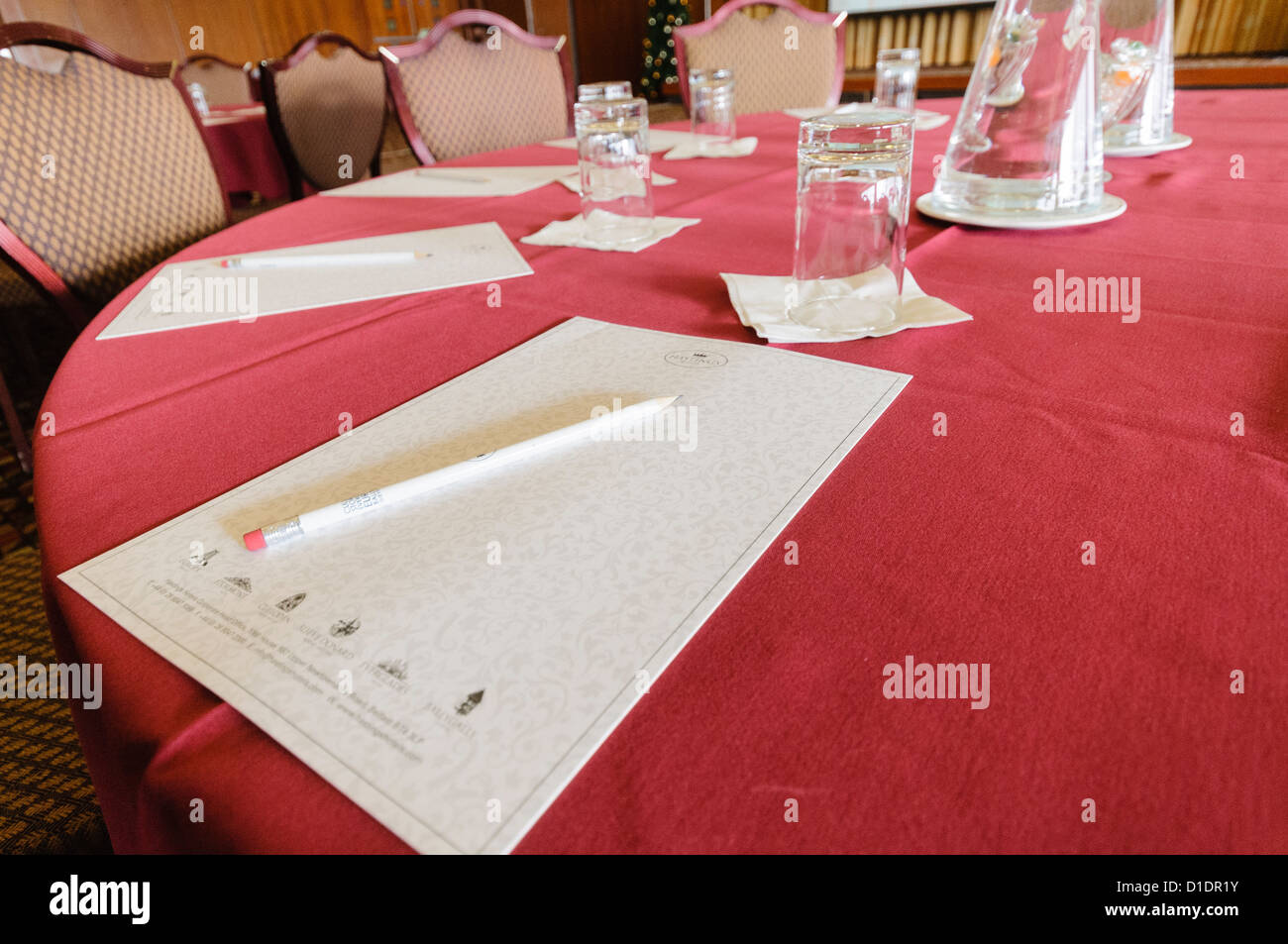 Paper and pencils left on the table in a hotel conference room. Stock Photo