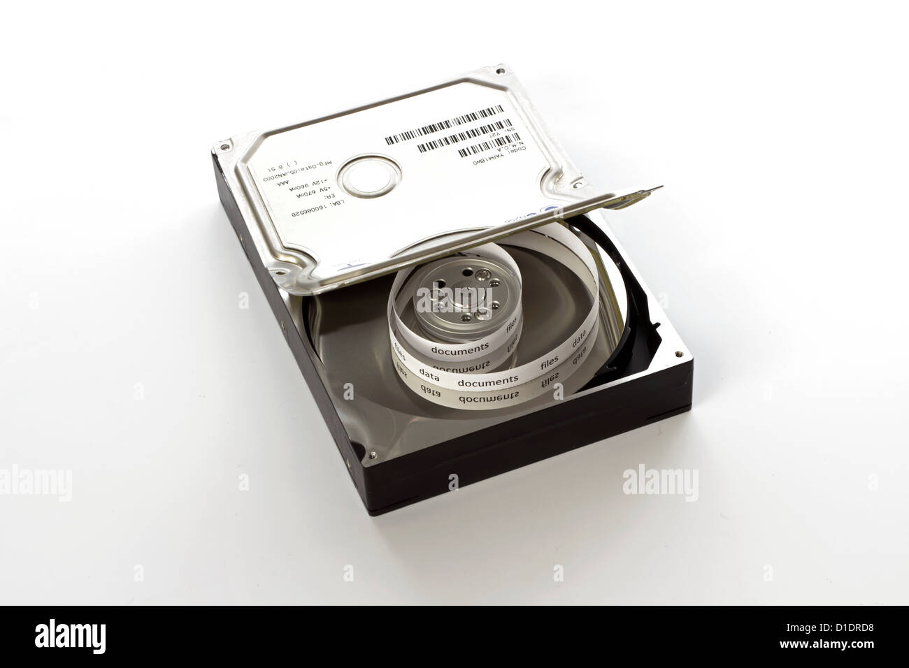 Half open hard drive and and a curly tape with files Stock Photo