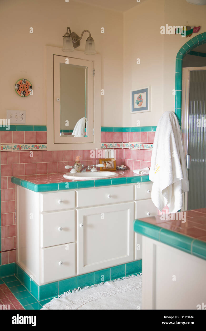 Bathroom sink and counter in pink and teal tiled bathroom; Carpinteria; California; USA Stock Photo
