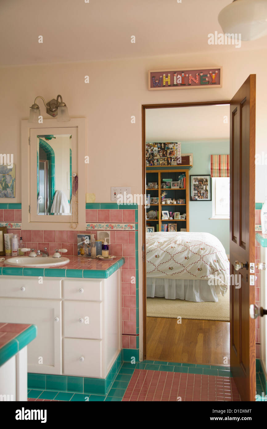 Pink and blue tiled bathroom between bedrooms; Carpinteria; California; USA Stock Photo