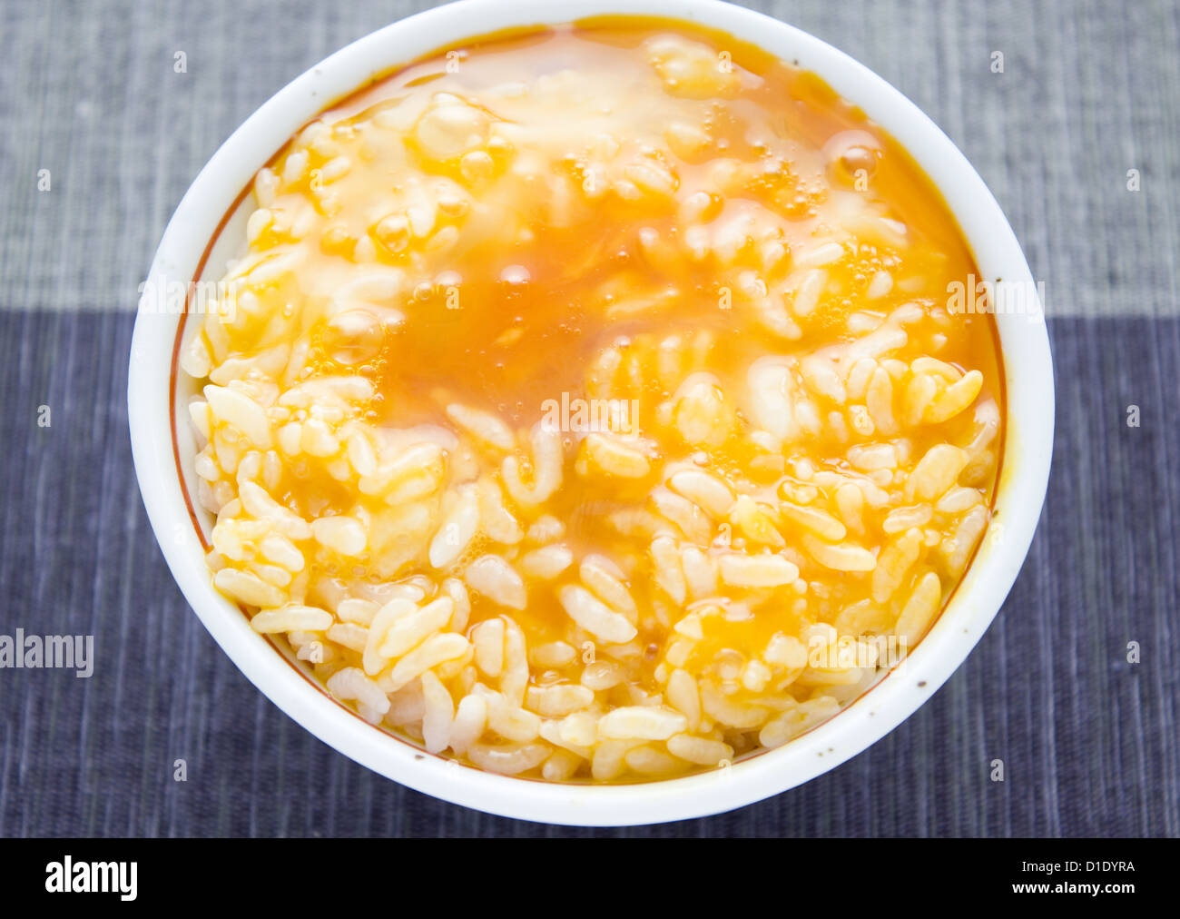 Raw egg sauce over rice Stock Photo Alamy