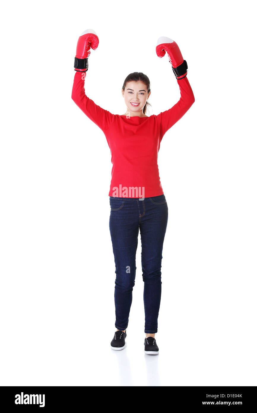 Young woman wearing a pair of boxing gloves. Holding hands up in victory gesture Stock Photo Alamy
