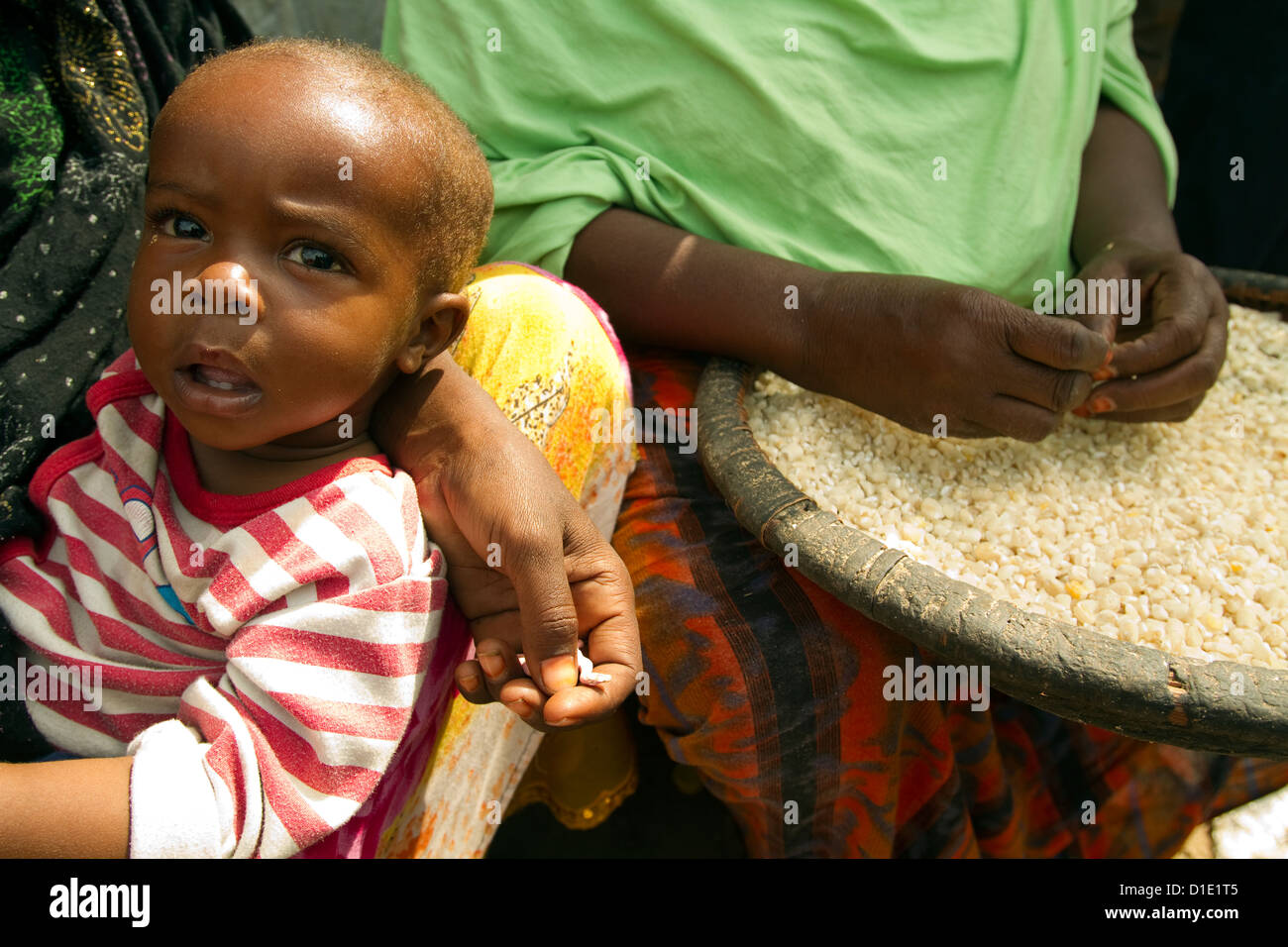 Somalis refugee women pounding corn seed distributed as food aid Mogadishu Somali Stock Photo
