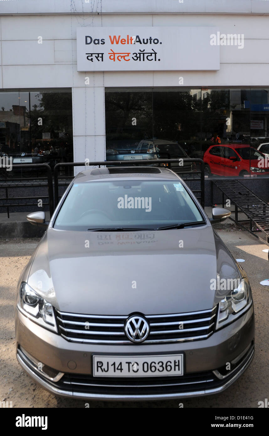 A VW Passat is parked in front of a VW car dealership in Jaipur, India, 19 November 2012. On the store front of the dealership, VW advertises with the slogan 'Das Weltauto' (The world car) in German and Hindi. Photo: Jens Kalaene Stock Photo