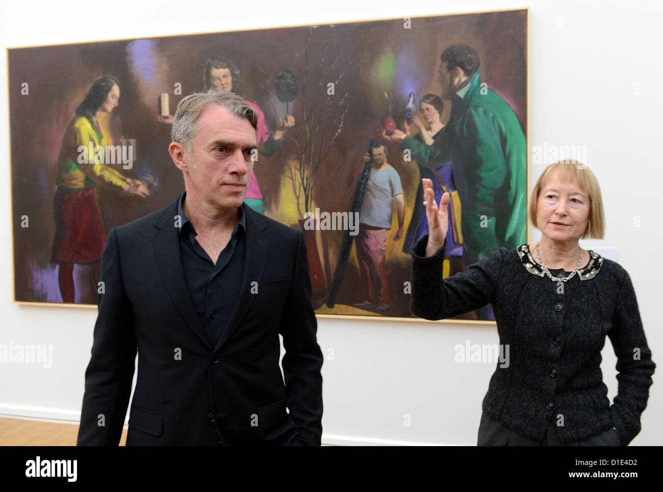 Artist Neo Rauch from Leipzig and Director-General of the Art collection Chemnitz Ingrid Moessinger stand in front of Rauch's painting 'Die Abwaegung' in Chemnitz, Germany, 14 December 2012. Rauch and his wife Rosa Loy exhibit together for the first time, with a total of 23 art works. Photo: Hendrik Schmidt Stock Photo
