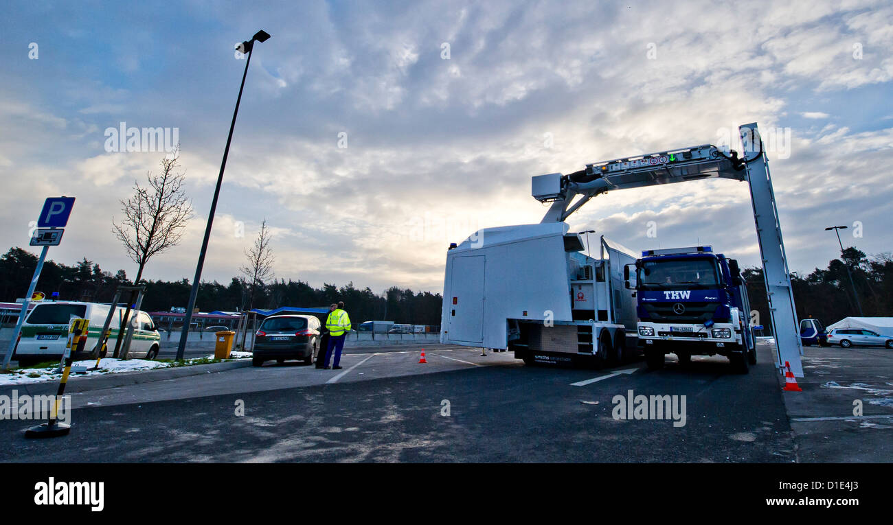 Truck of the German Federal Agency for Technical Relief (THW) stands under a mobile radiological unit of the customs while a test maesurment is conducted in Graefehausen, Germany, 12 December 2012. Customs investigators use this unit for the first time in order to X-ray trucks in search of drugs or smuggled cigarettes. Photo: Nicolas Armer Stock Photo
