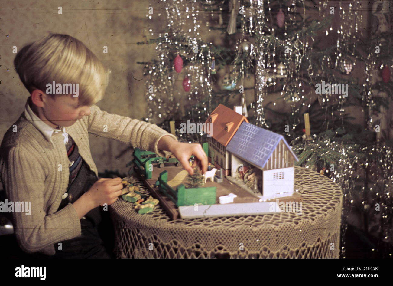Christmas in the post-war period - a boy plays with his Christmas gift, a toy farm, on Christmas Eve 1947. Photo: ddrbildarchiv.de/Bonitz Stock Photo