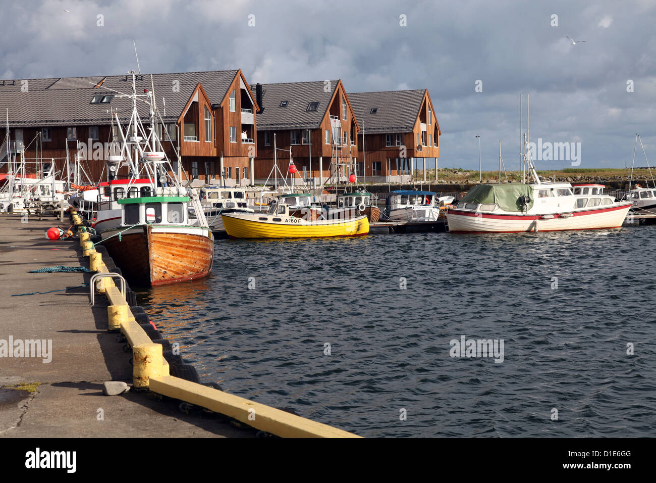 Holiday apartments and fishing boats alongside the harbour at Lista, Vest-Agder, west Norway, Norway, Scandinavia, Europe Stock Photo