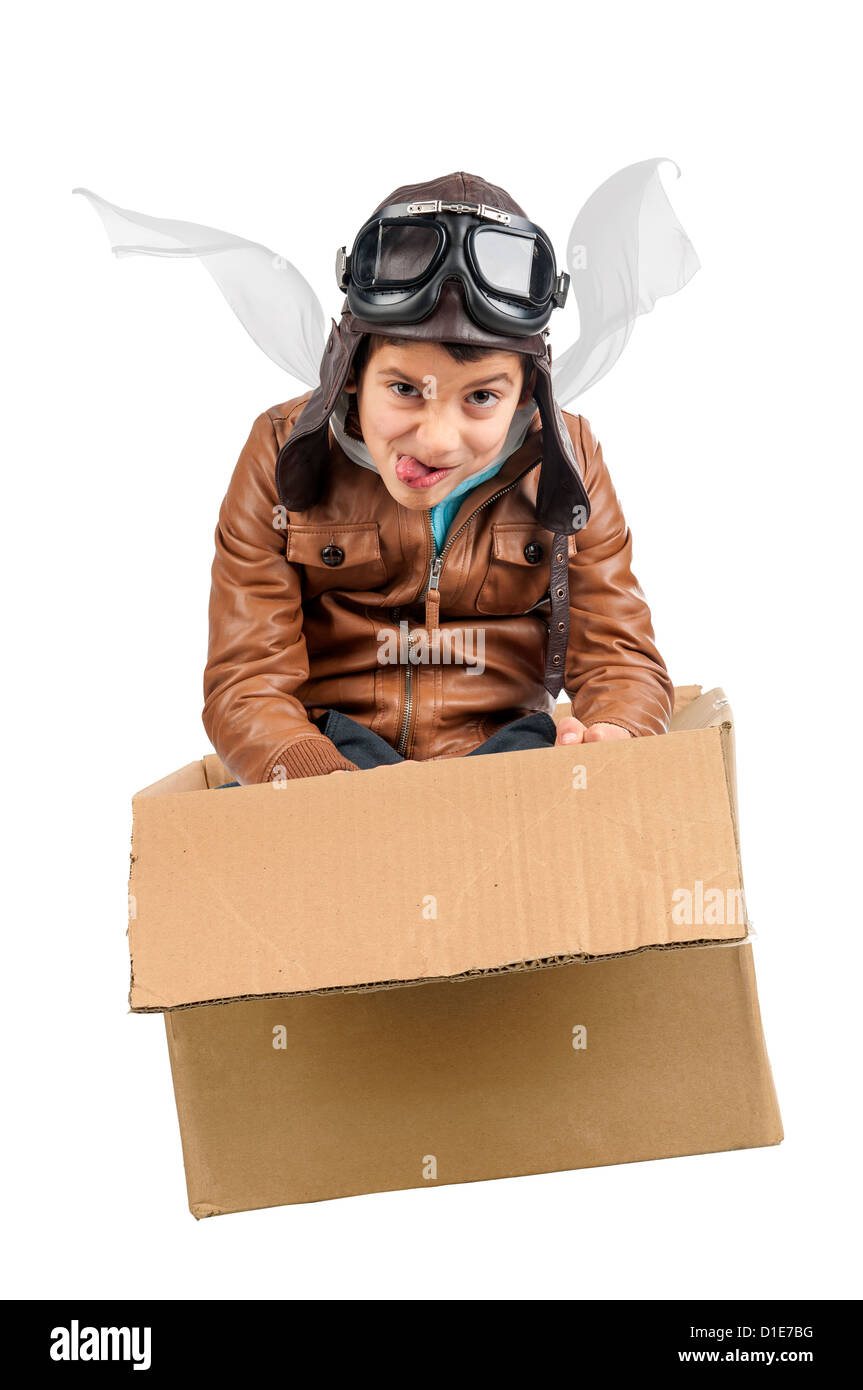 Young boy pilot flying a cardboard box isolated in white Stock Photo